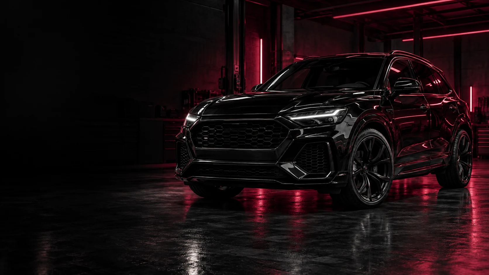 Automóvil negro en un taller con iluminación rojo vino